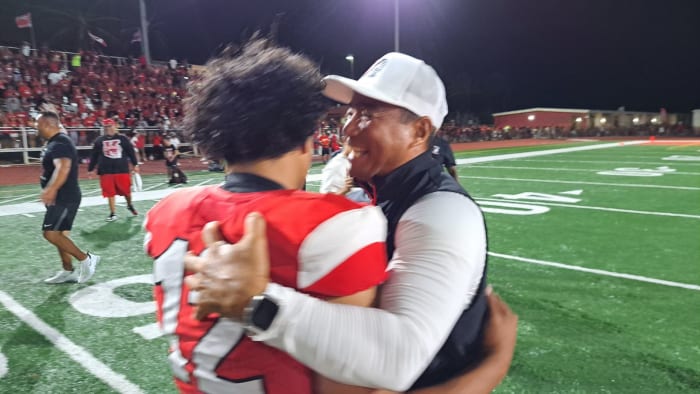 Tuli Tagovailoa-Amosa (12) is greeted by head coach Sterling Carvalho after stunning 30-23 win over St. John Bosco. Photo: Heston Quan.